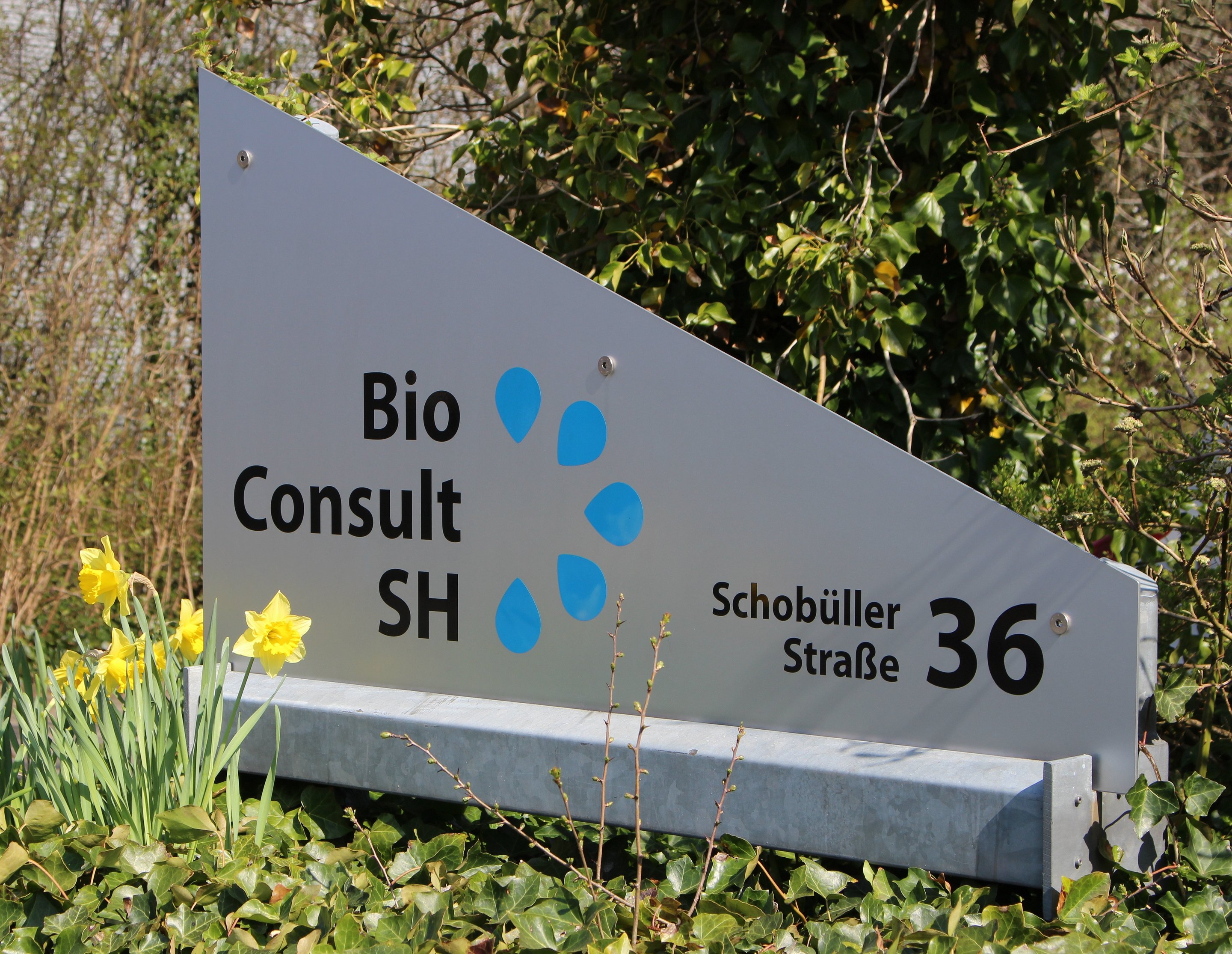 A plate with the company logo and address of BioConsult SH.