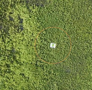An aerial view of a GCP (Ground Control Point), a black and white plate that can be used to accurately measure the location of drone footage.